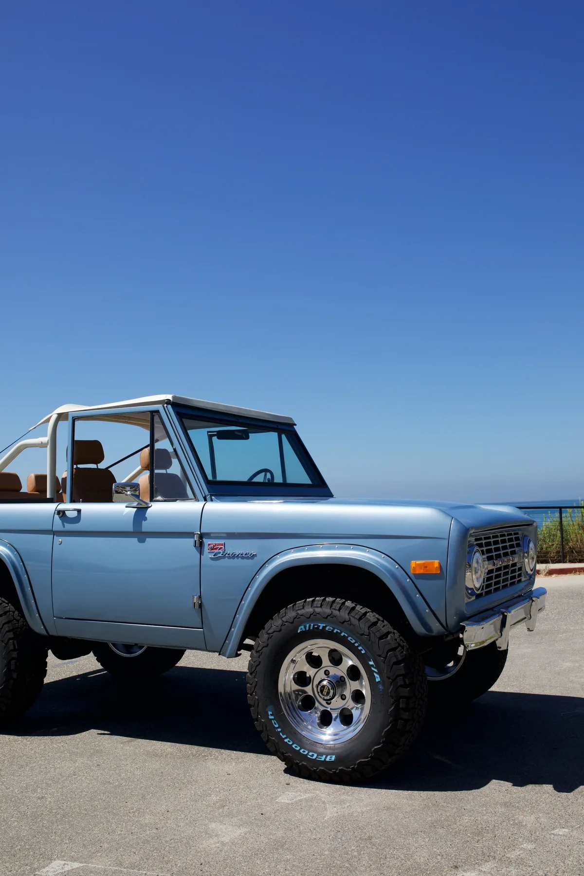 Blue Bird — light blue Bronco at dusk by the ocean