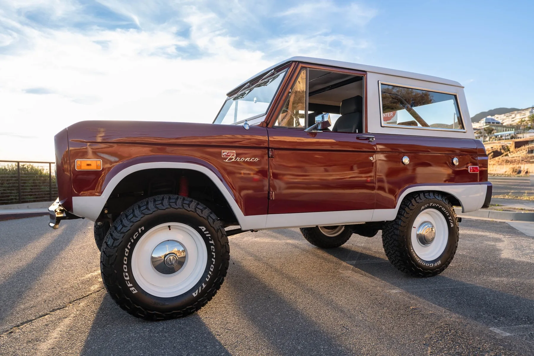 Crimson — deep maroon Bronco on a tree-lined street