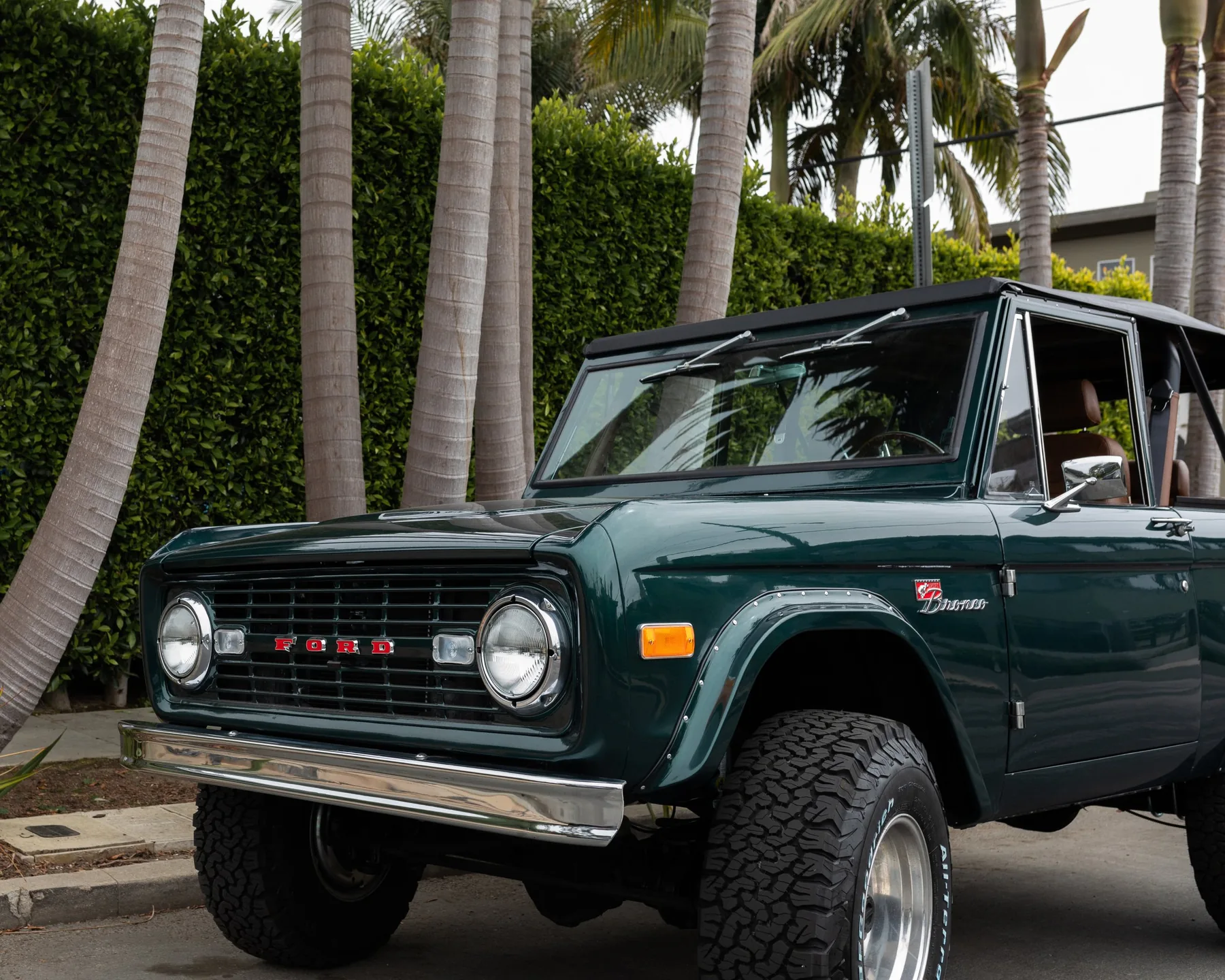 Green Bean — emerald green Bronco in front of the palms
