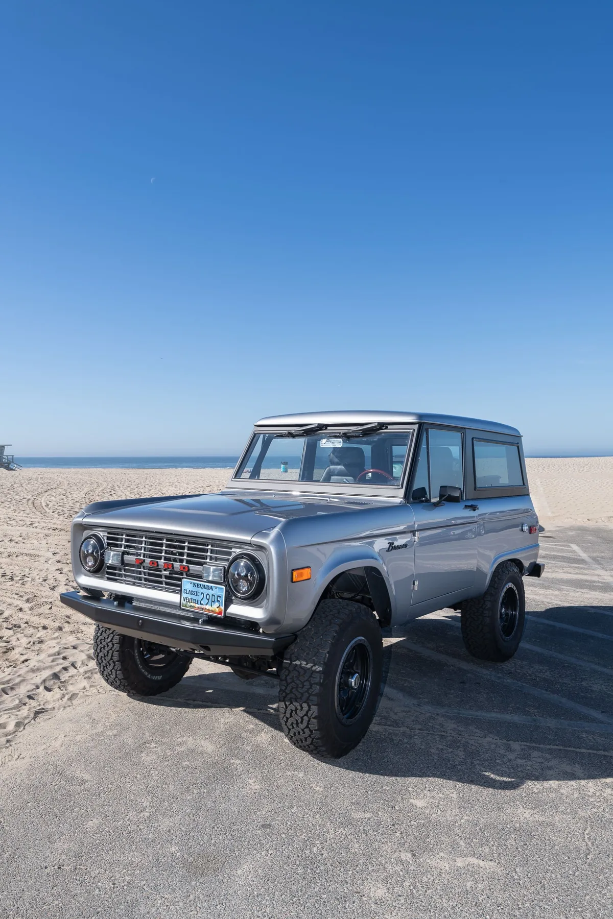 Luna — silver-blue Bronco parked on the sand