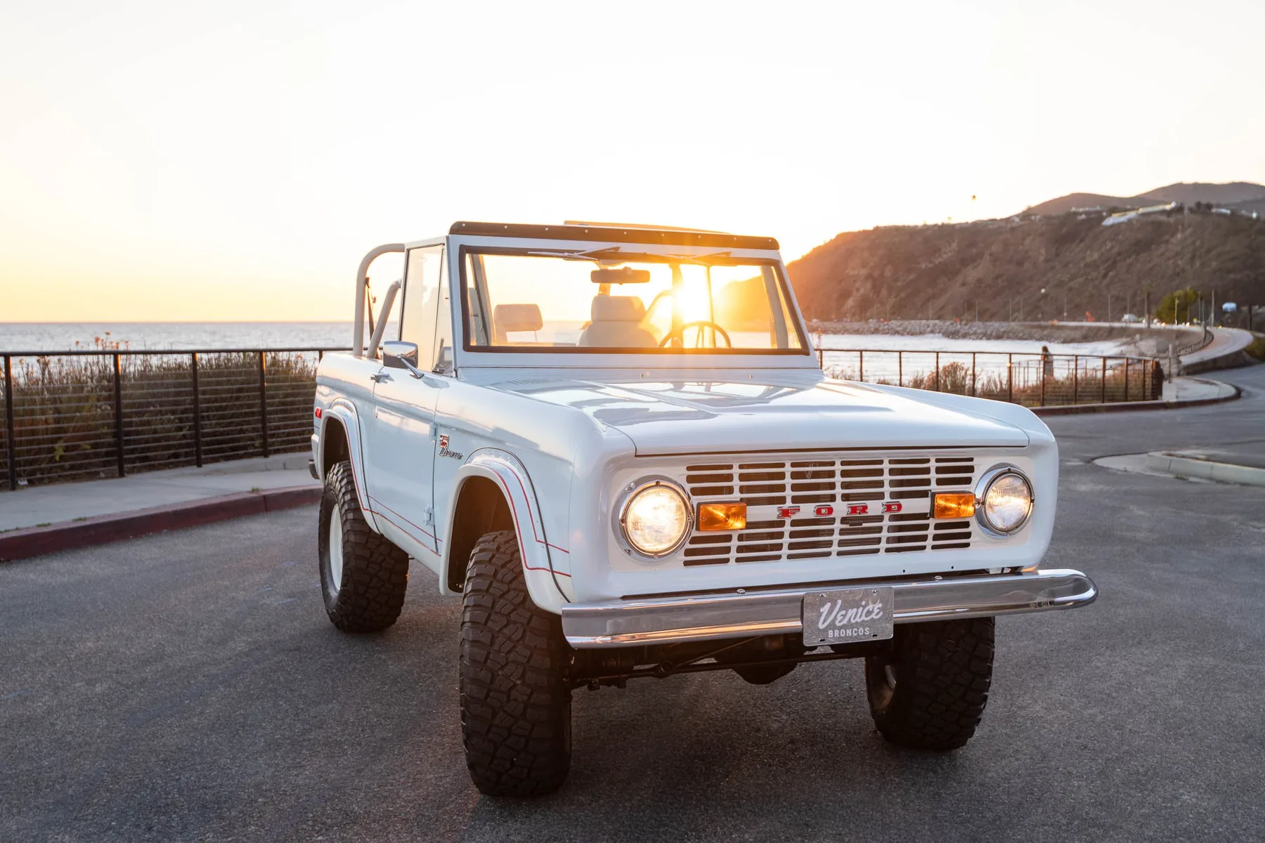 Robin's Egg — pale blue 1976 Bronco at sunset over the Pacific
