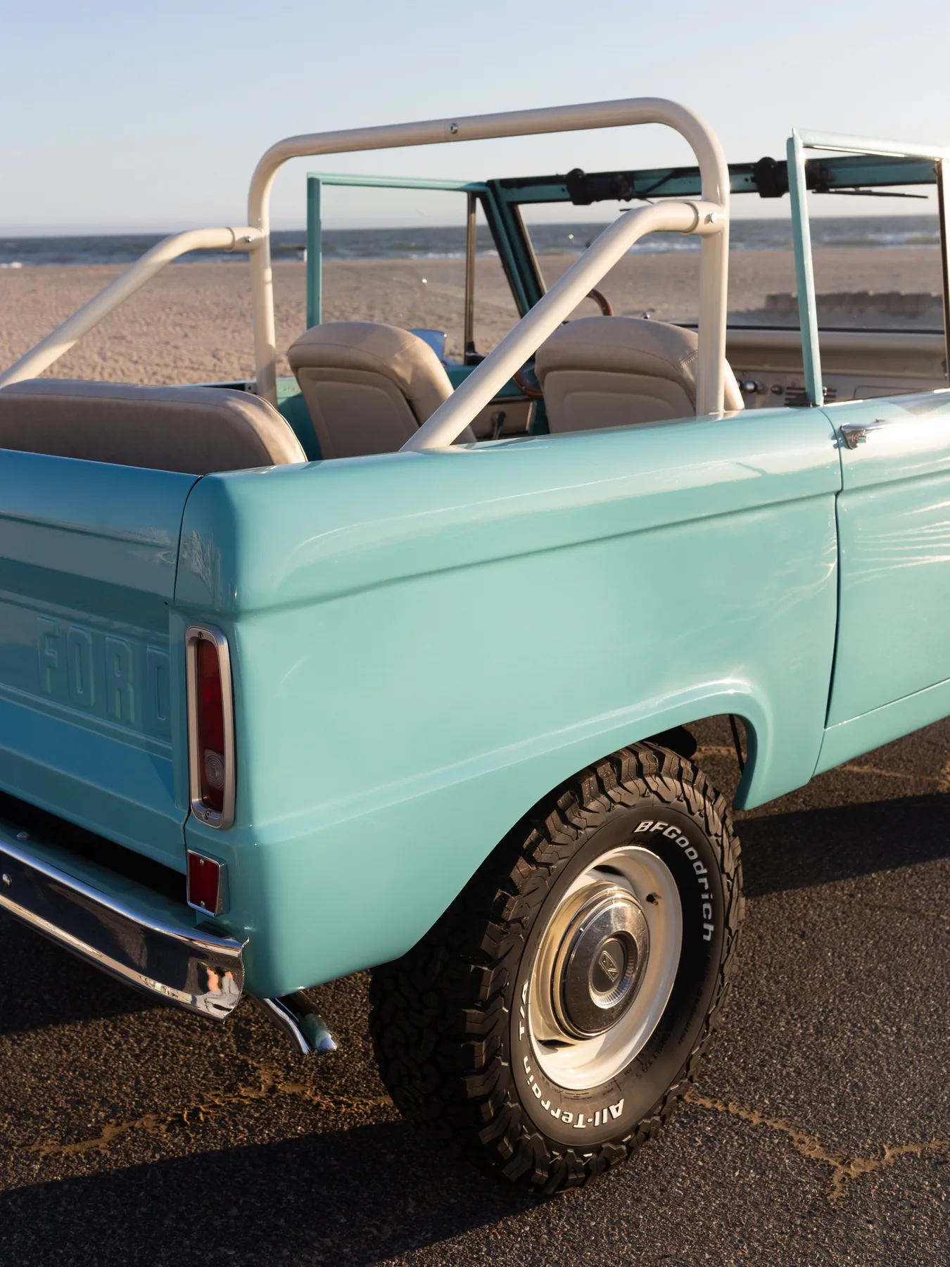 The Rooster — peacock blue Bronco at golden hour