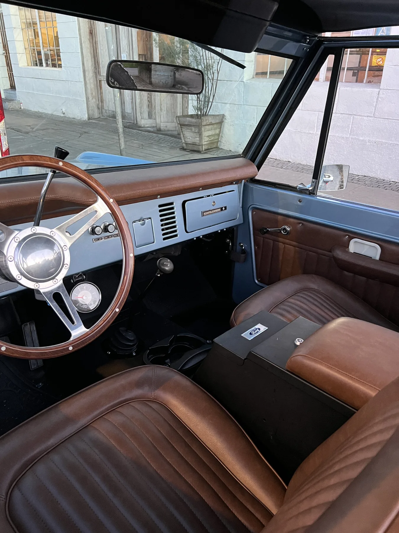 Saddle leather buckets and wood-rim steering wheel