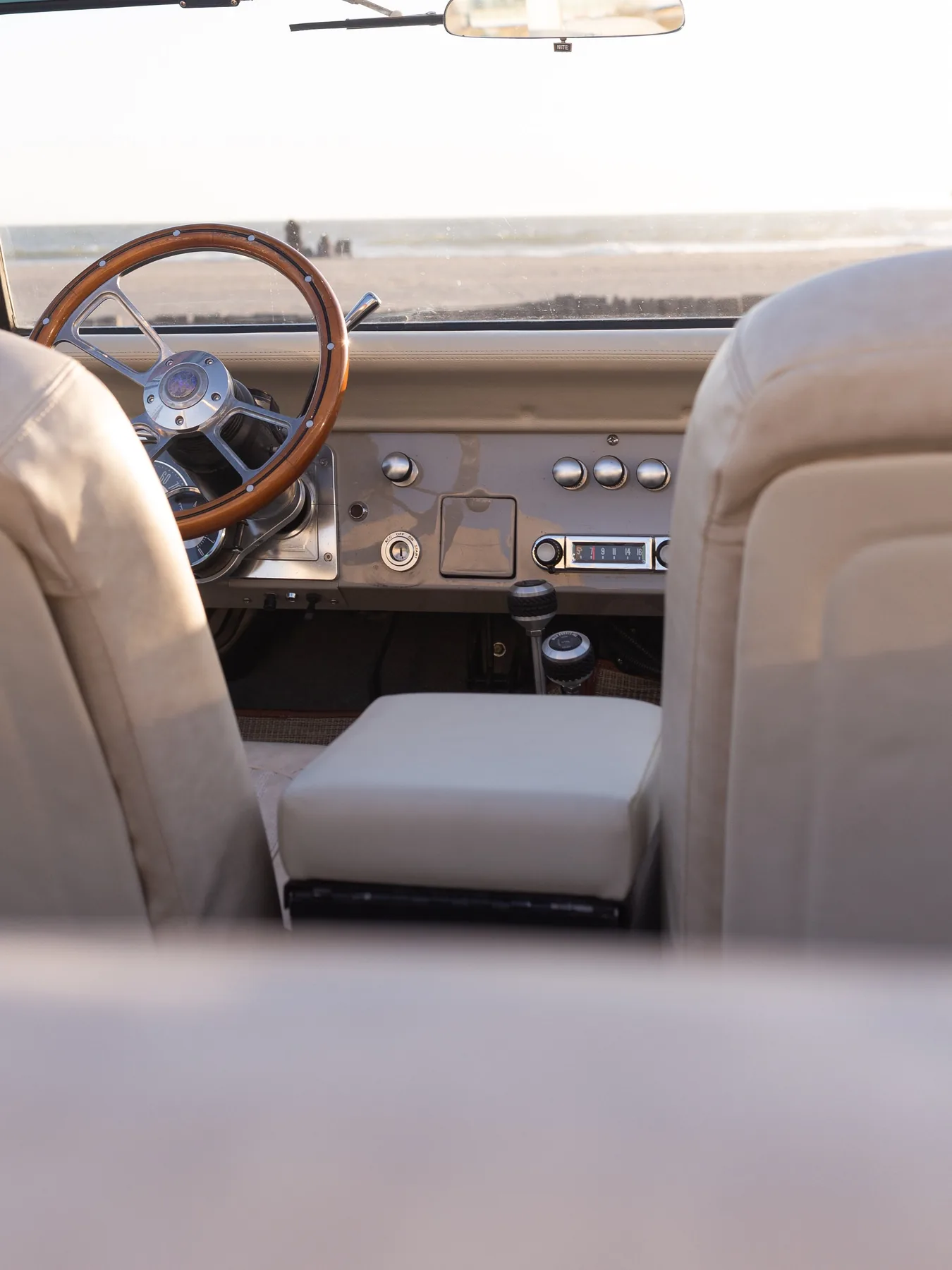 Wood-rim wheel with ocean view through the windshield