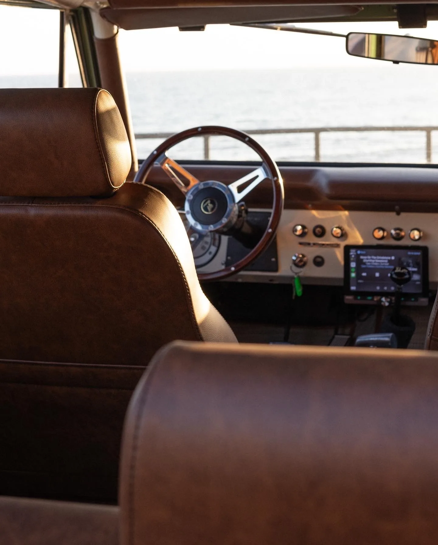 Touchscreen head unit in a classic dash overlooking the ocean